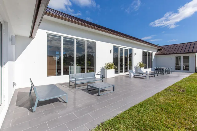 a building outdoor space with patio furniture and potted plants