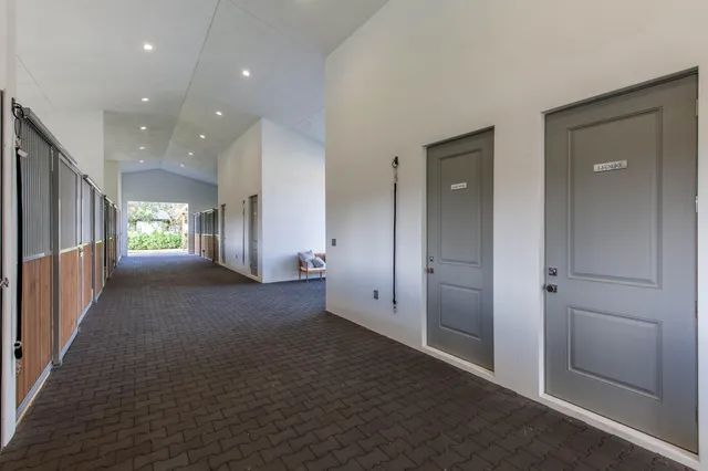 an empty room with windows and entrance to other room