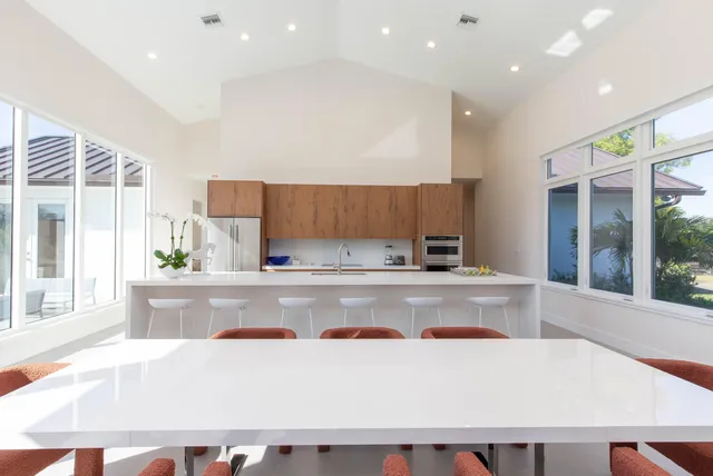 a view of kitchen with stainless steel appliances granite countertop refrigerator sink and stove