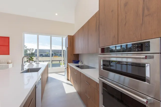 a kitchen with stainless steel appliances a stove sink and cabinets