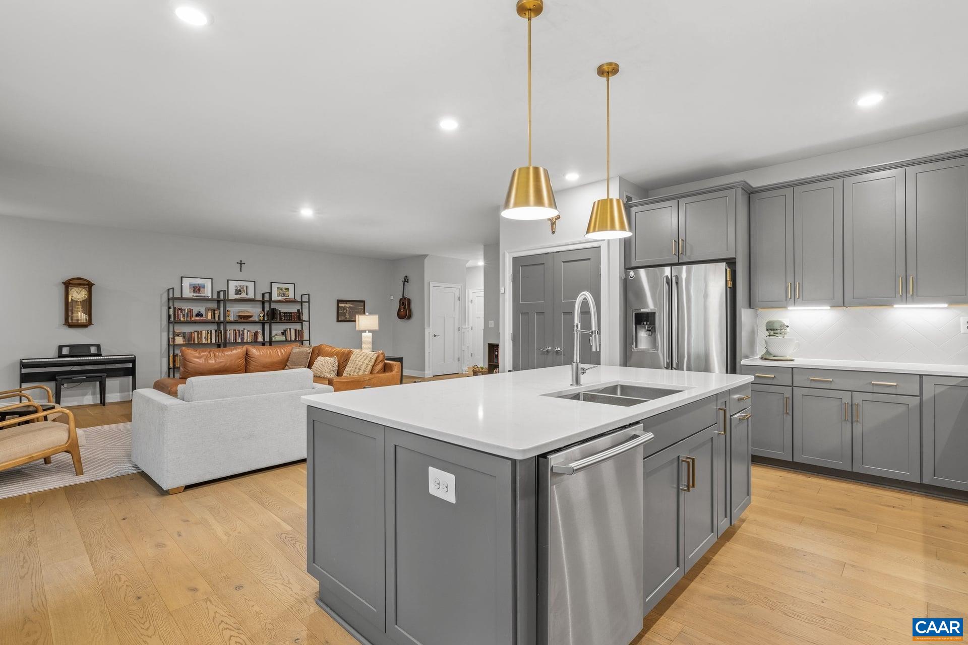 271 Two Rivers Drive Troy, VA 22974 - Photo 20 of 63 a kitchen that has a lot of cabinets a sink and a wooden floor