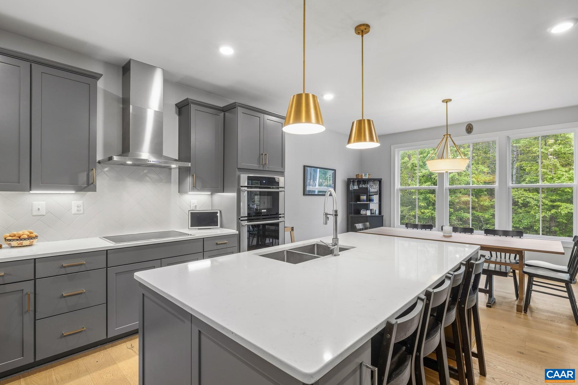 271 Two Rivers Drive Troy, VA 22974 - Photo 21 of 63 a kitchen with stainless steel appliances a table chairs and windows