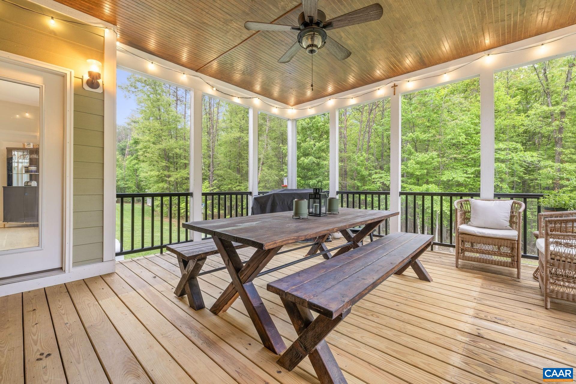 271 Two Rivers Drive Troy, VA 22974 - Photo 25 of 63 a living room with large trees and wooden floor