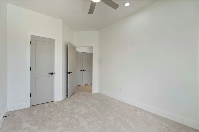 an empty room with a empty space and a ceiling fan