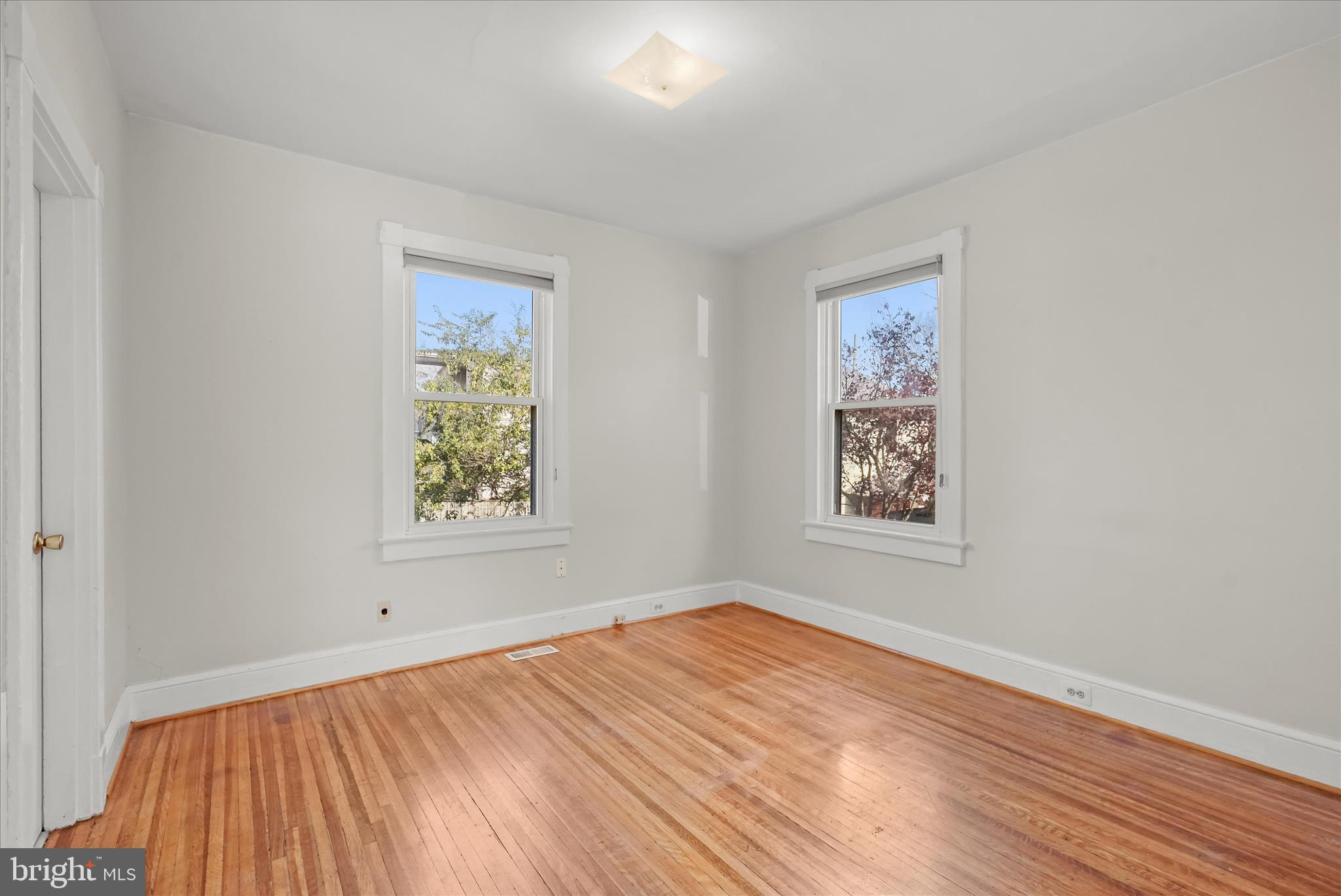 1342 Hamlin Street Northeast Washington, DC 20017 - Photo 13 of 32 wooden floor in an empty room with a window