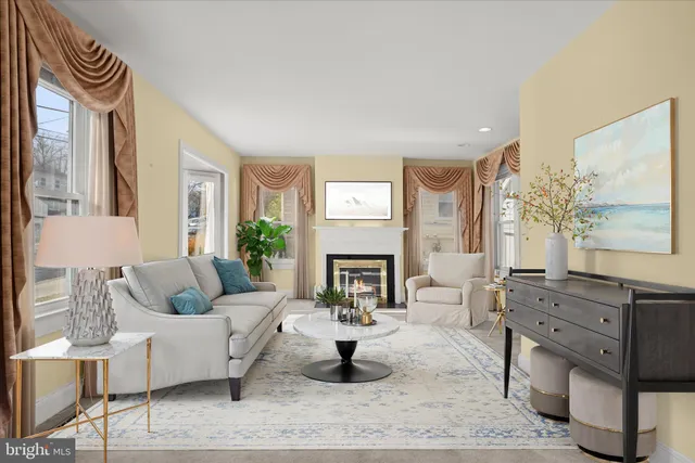 a living room with furniture and a fireplace