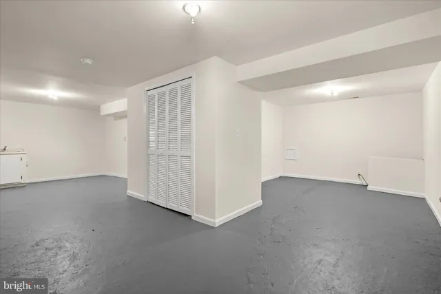 a view of backyard of house with wooden deck and seating space