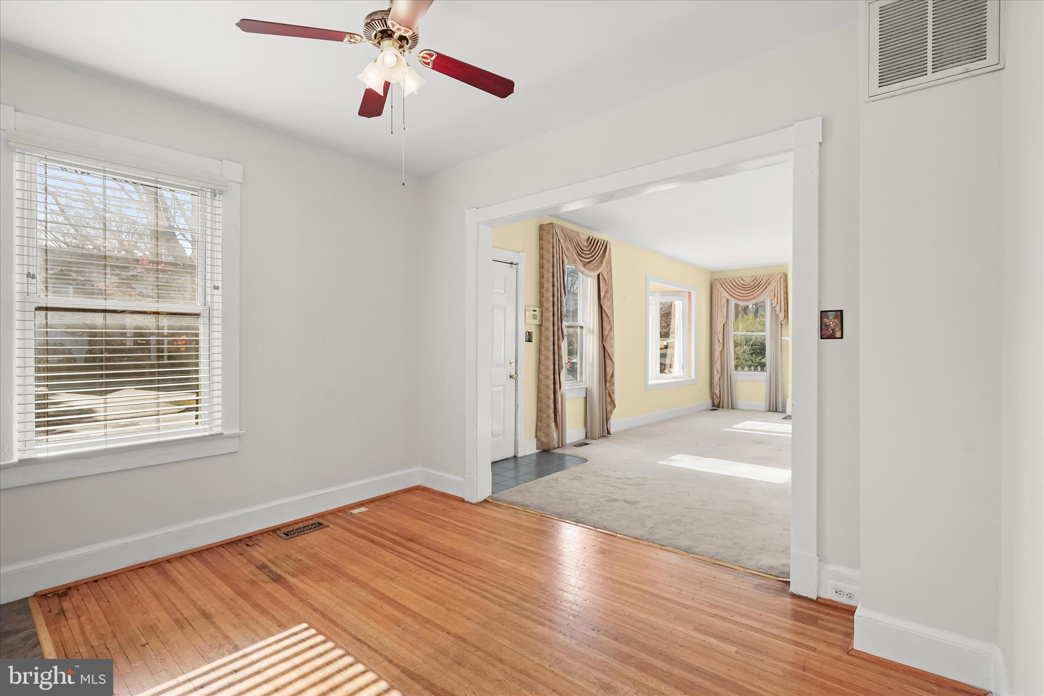 1342 Hamlin Street Northeast Washington, DC 20017 - Photo 8 of 32 a view of an empty room with wooden floor and a window