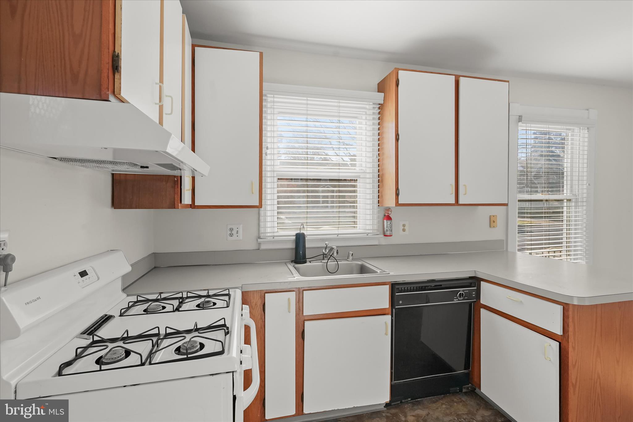 1342 Hamlin Street Northeast Washington, DC 20017 - Photo 10 of 32 a kitchen with sink a stove and white cabinets