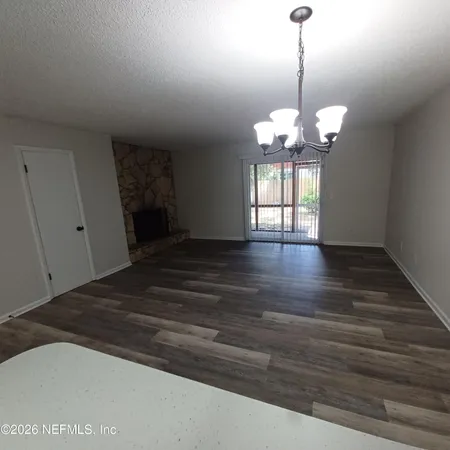 a view of a chandelier fan and wooden floor