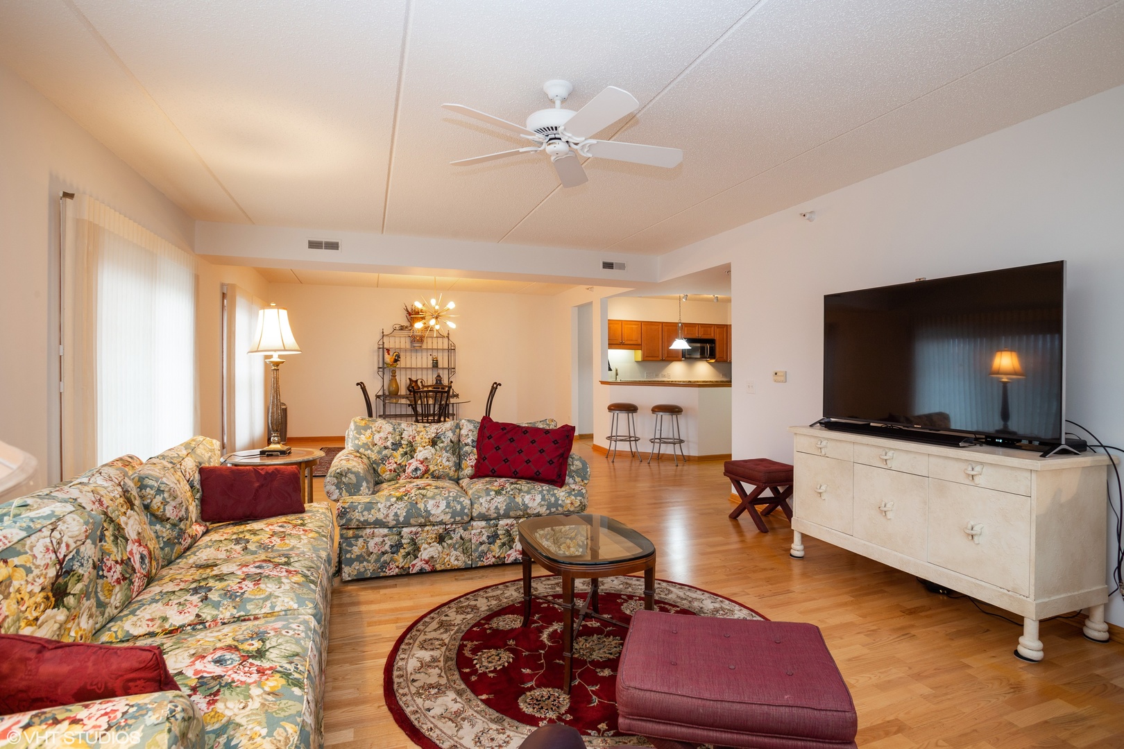 601 West Rand Road, Unit 202A Arlington Heights, IL 60004 - Photo 2 of 10 a living room with furniture and a flat screen tv