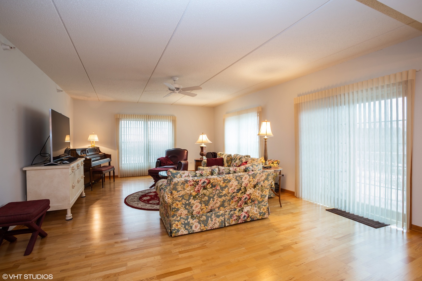 601 West Rand Road, Unit 202A Arlington Heights, IL 60004 - Photo 3 of 10 a living room with furniture a flat screen tv and a large window