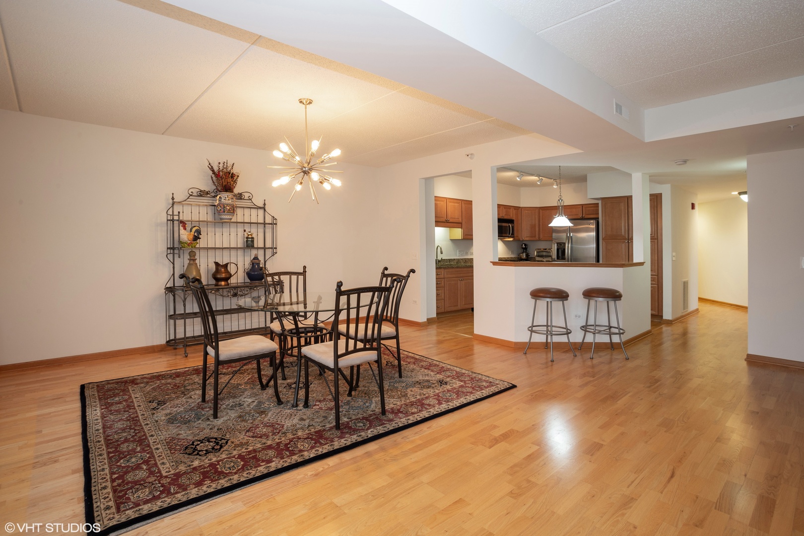 601 West Rand Road, Unit 202A Arlington Heights, IL 60004 - Photo 4 of 10 a view of a dining room with furniture and wooden floor