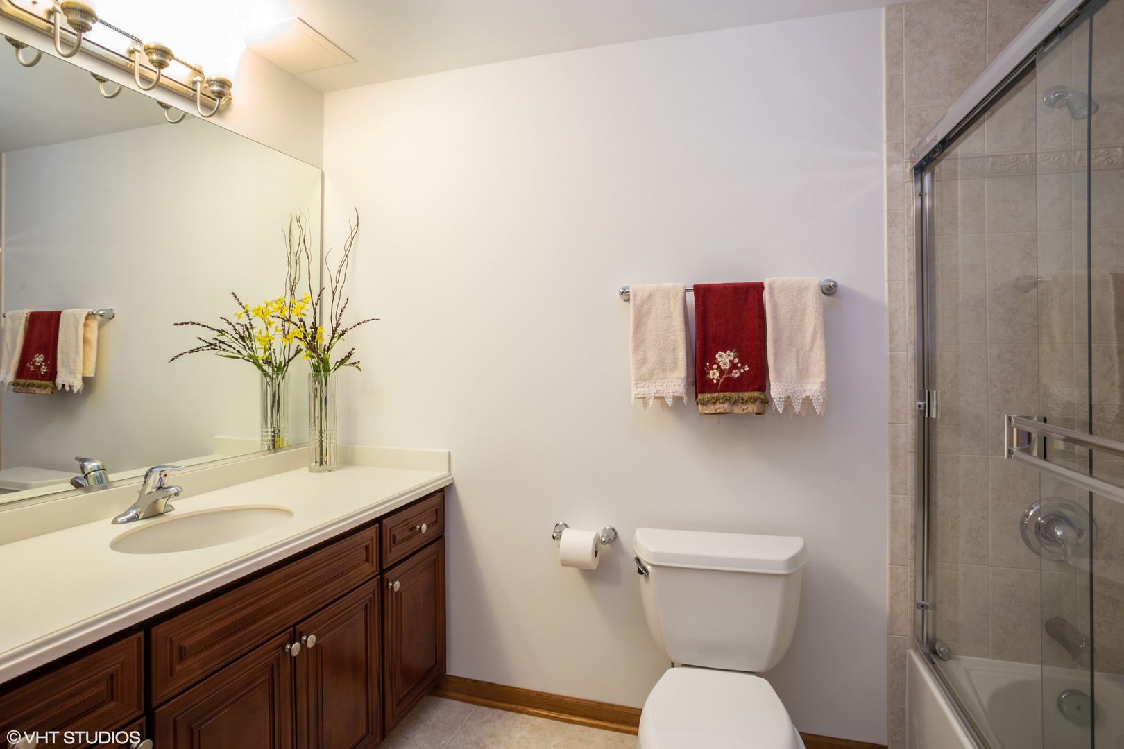 601 West Rand Road, Unit 202A Arlington Heights, IL 60004 - Photo 9 of 10 a bathroom with a toilet sink and mirror