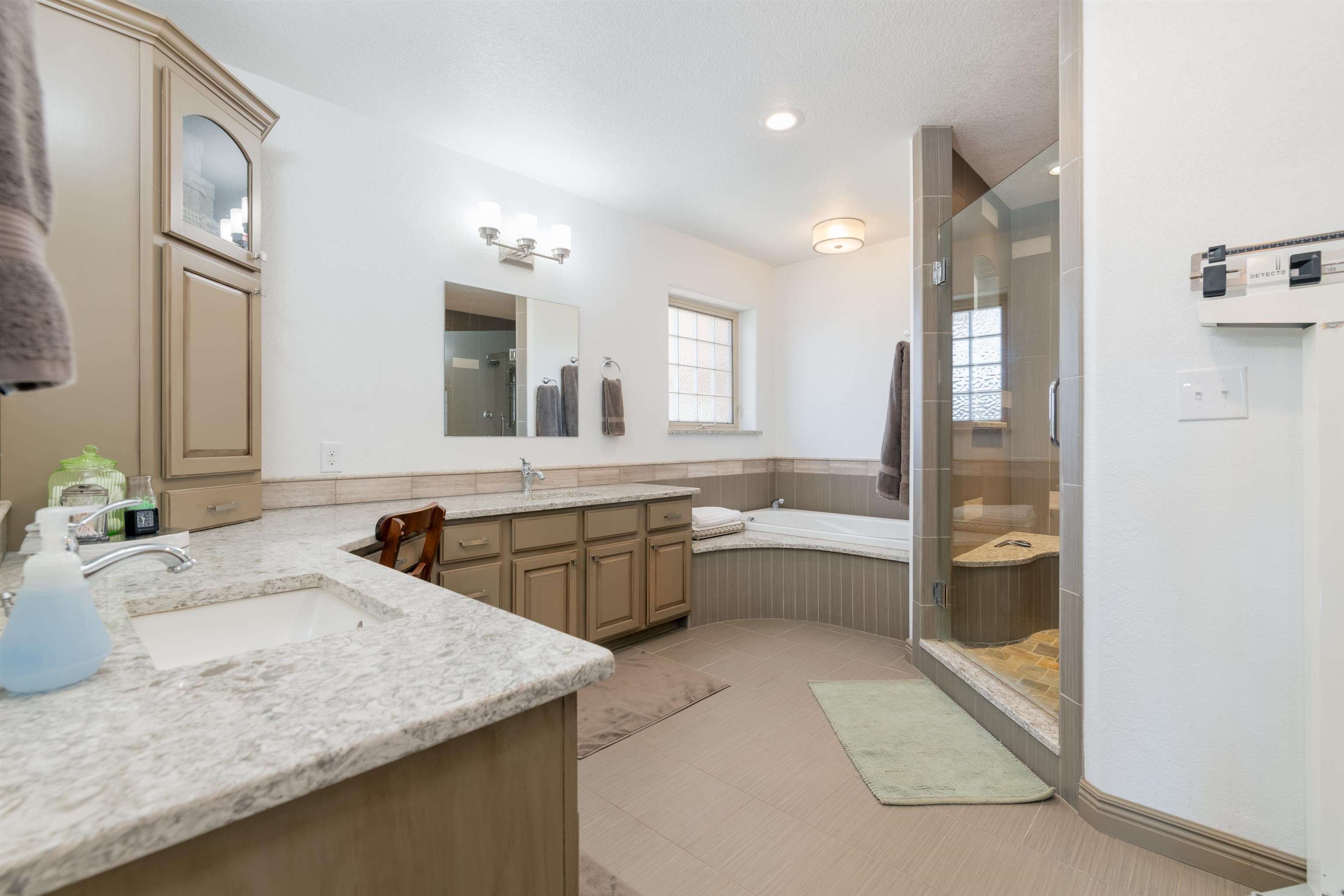 2120 I Road Grand Junction, CO 81505 - Photo 14 of 42 a bathroom with a granite countertop sink mirror and bathtub