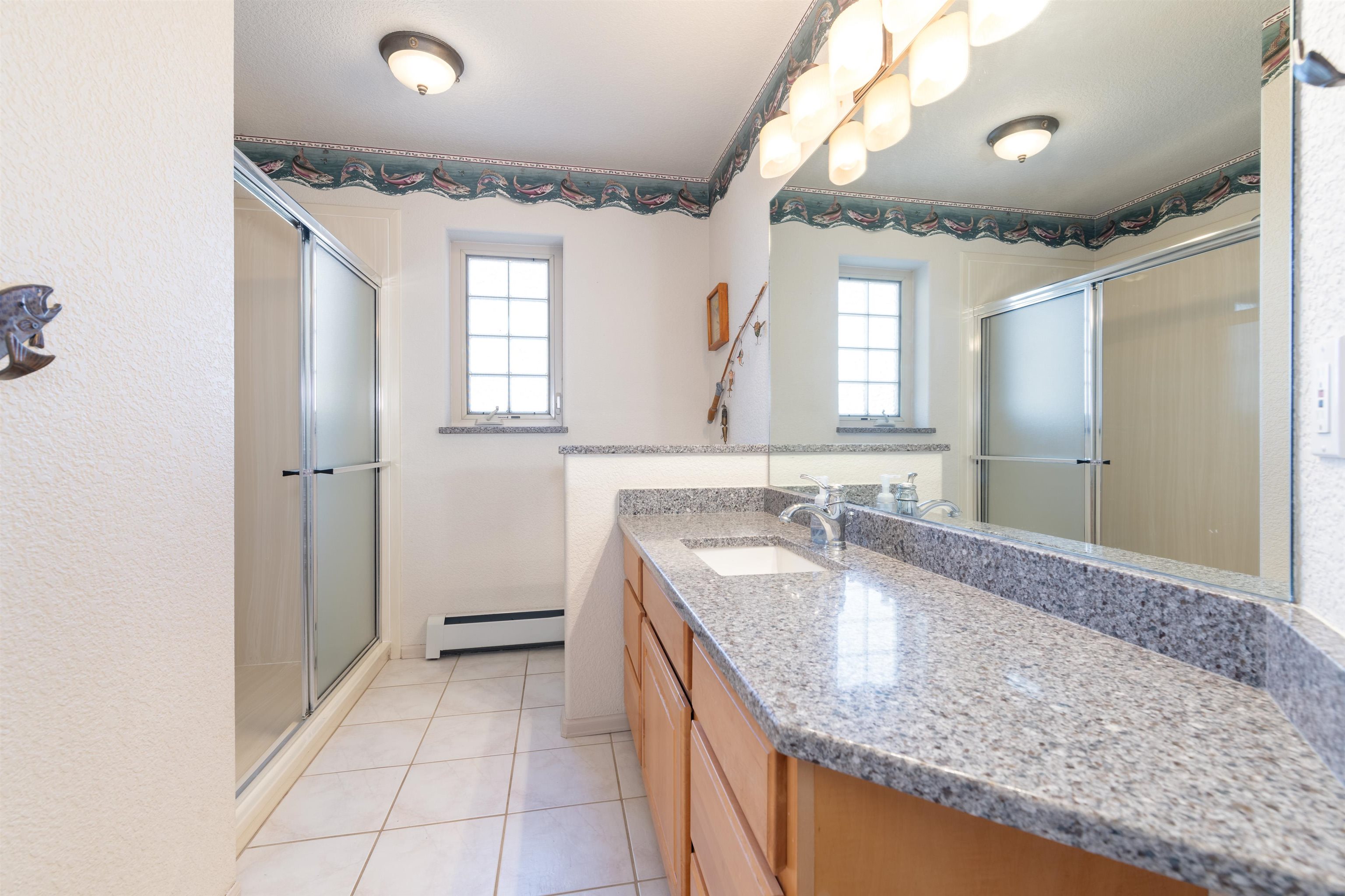 2120 I Road Grand Junction, CO 81505 - Photo 17 of 42 a bathroom with a granite countertop sink a mirror and a shower