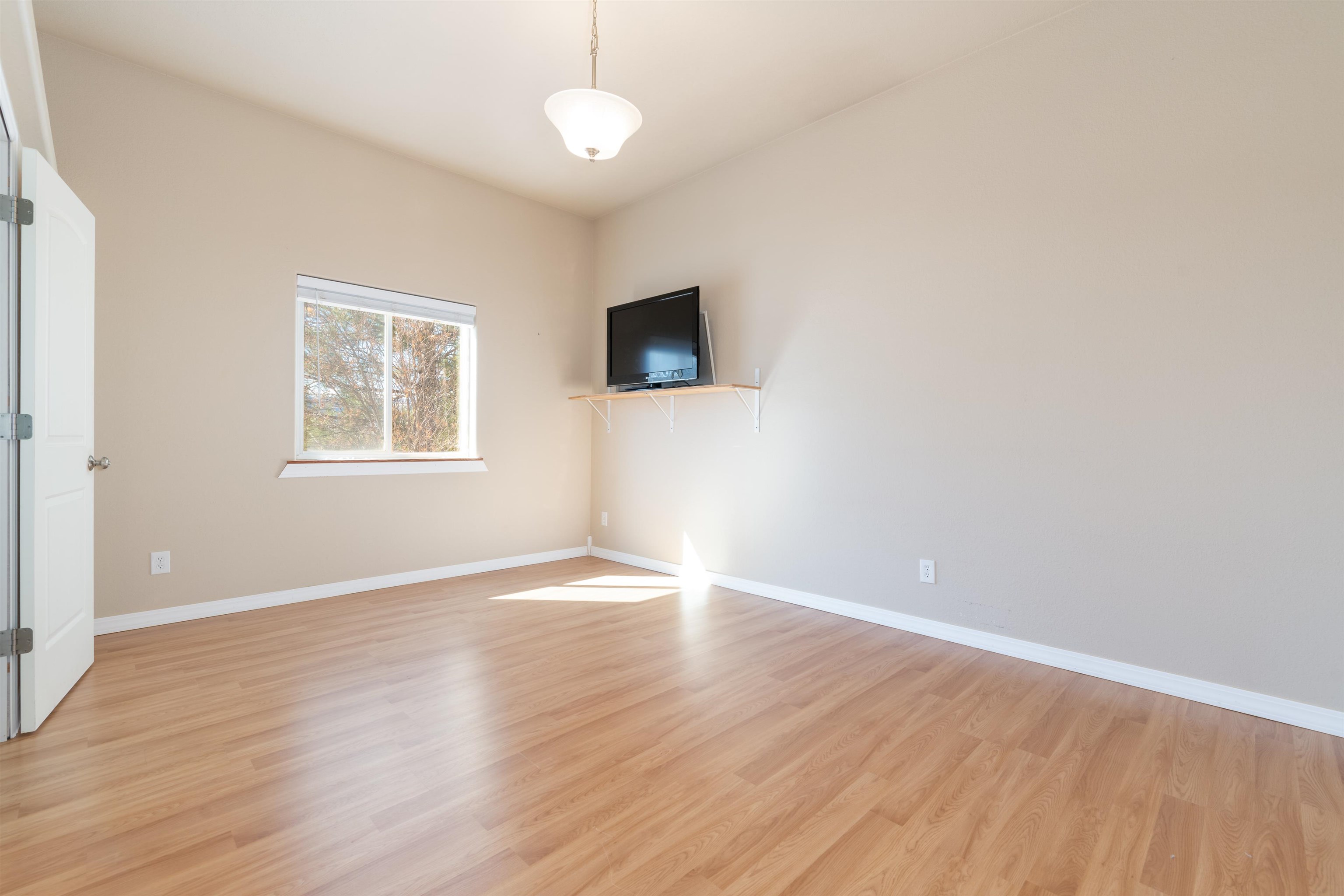 2120 I Road Grand Junction, CO 81505 - Photo 24 of 42 an empty room with wooden floor and windows