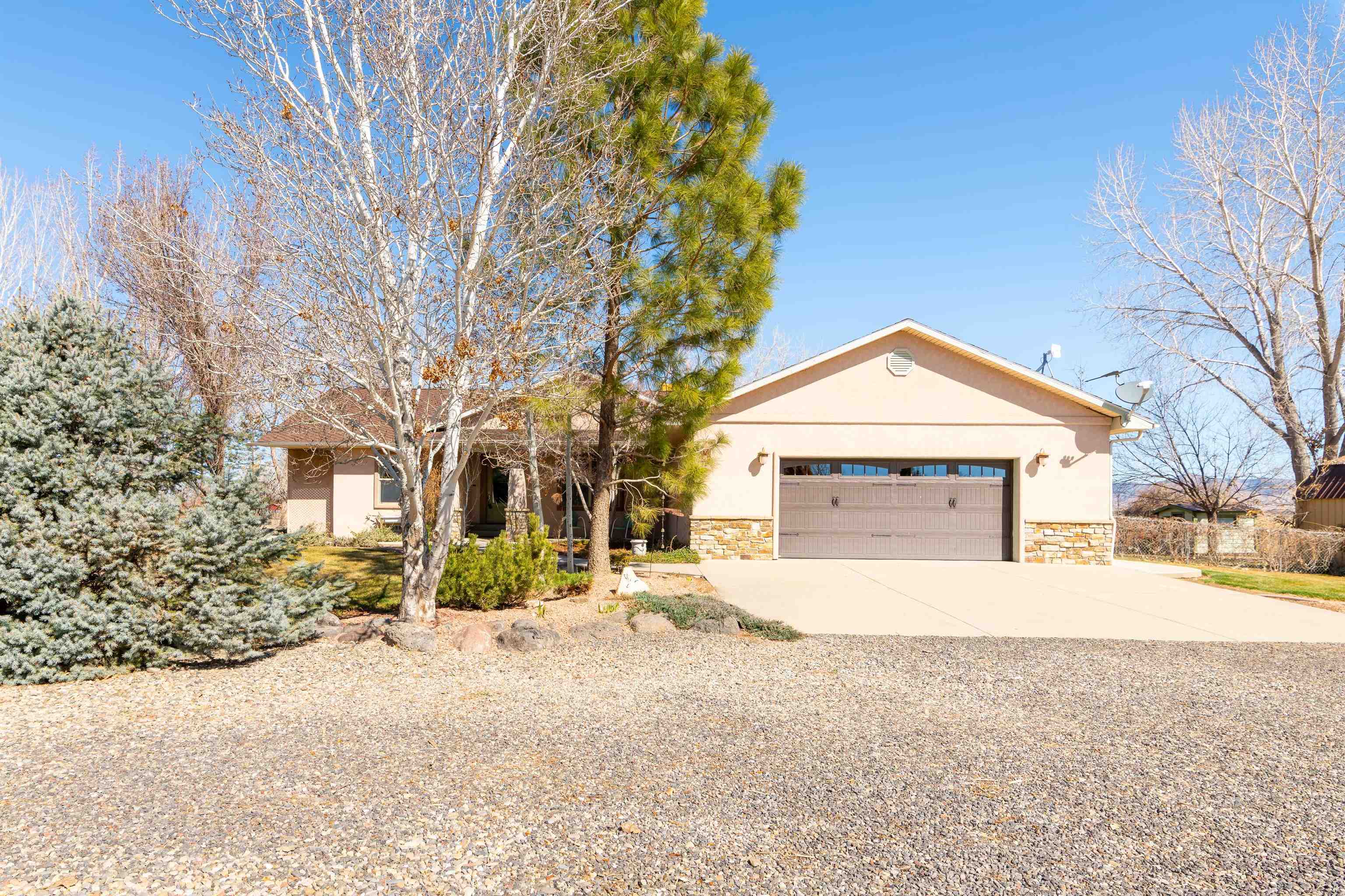 2120 I Road Grand Junction, CO 81505 - Photo 3 of 42 a front view of a house with a yard and garage
