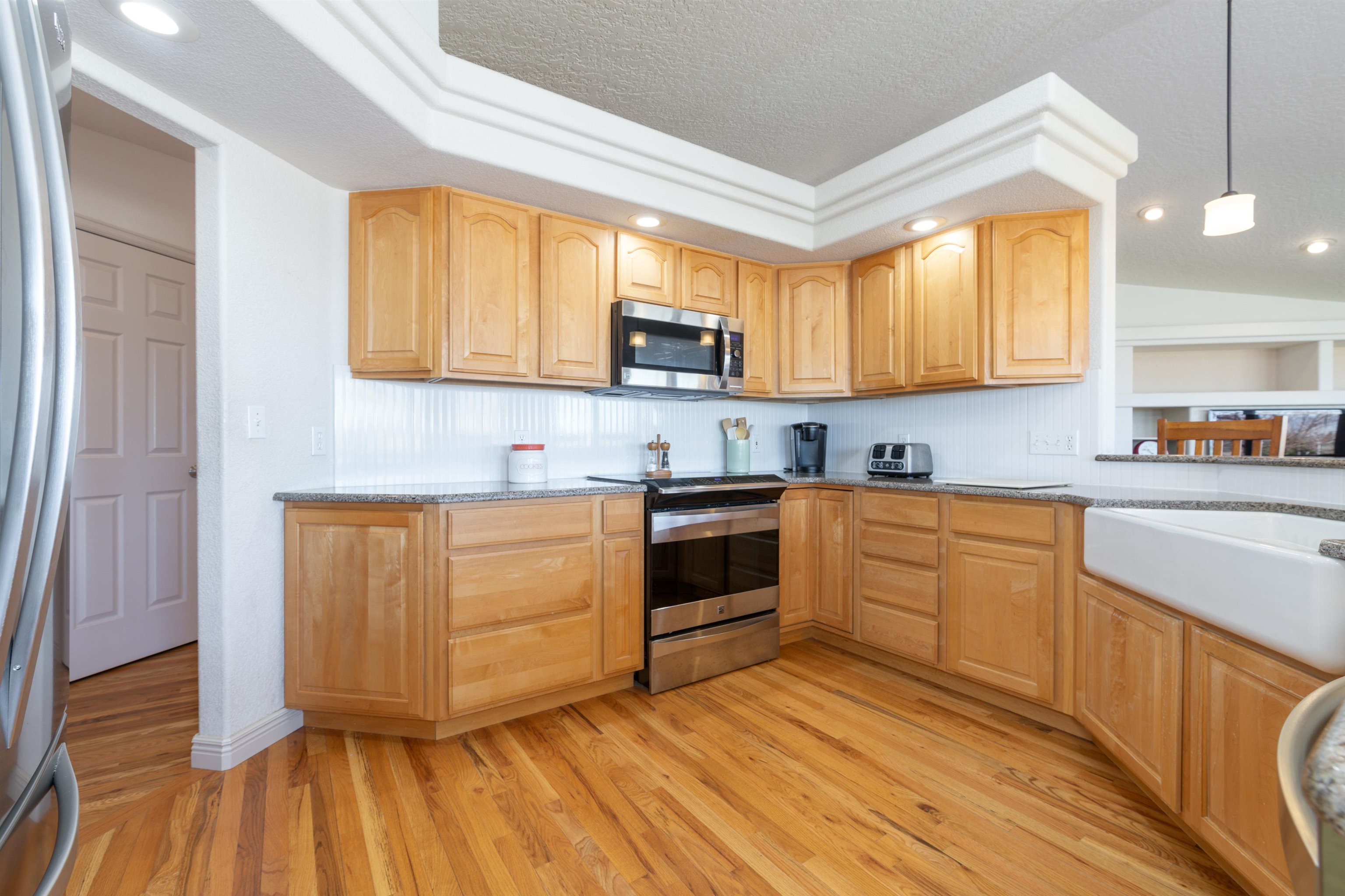 2120 I Road Grand Junction, CO 81505 - Photo 5 of 42 a kitchen with wooden floors and white appliances