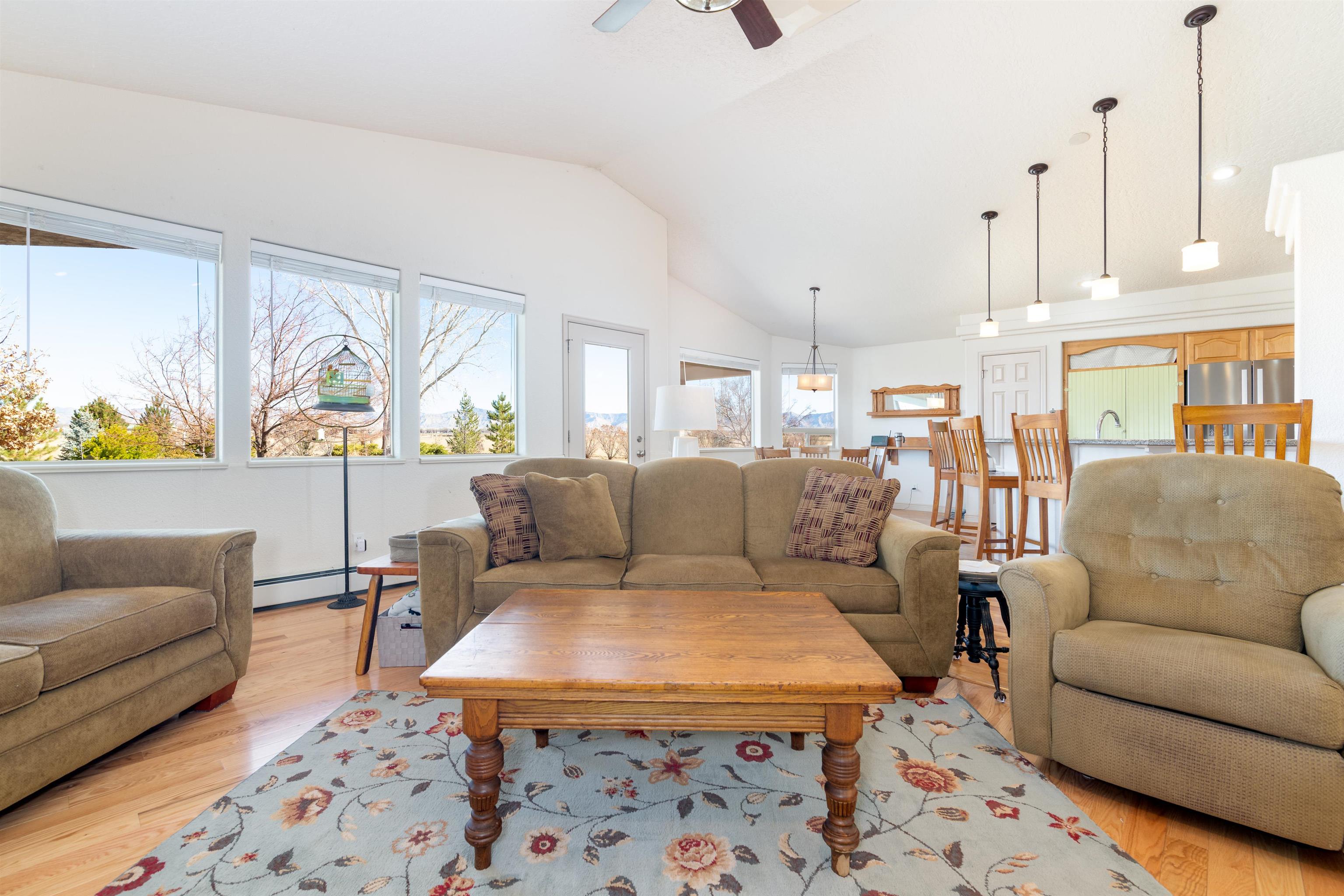 2120 I Road Grand Junction, CO 81505 - Photo 9 of 42 a living room with furniture wooden floor and a large window