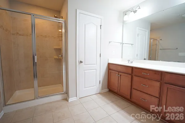a spacious bathroom with a shower and a sink