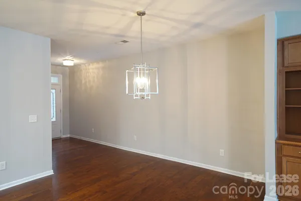 a view of a room with window and hardwood