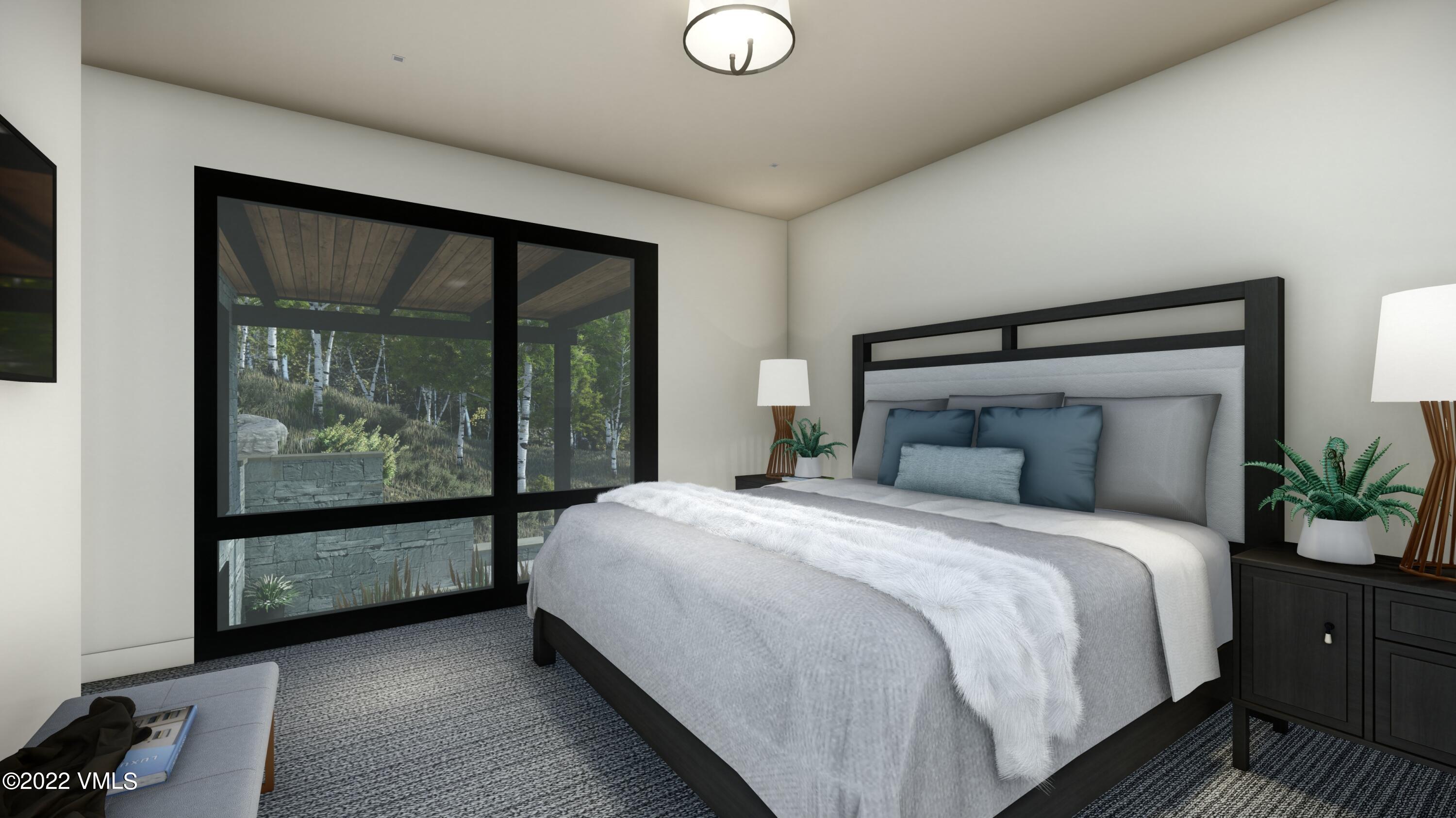 2965 Manns Ranch Road Vail, CO 81657 - Photo 15 of 26 a bedroom with a large bed and a large window