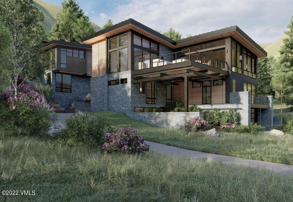 2965 Manns Ranch Road Vail, CO 81657 - Photo 24 of 26 a front view of a house with a garden