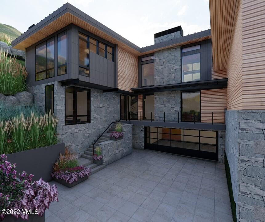 2965 Manns Ranch Road Vail, CO 81657 - Photo 25 of 26 a front view of a house with a garden