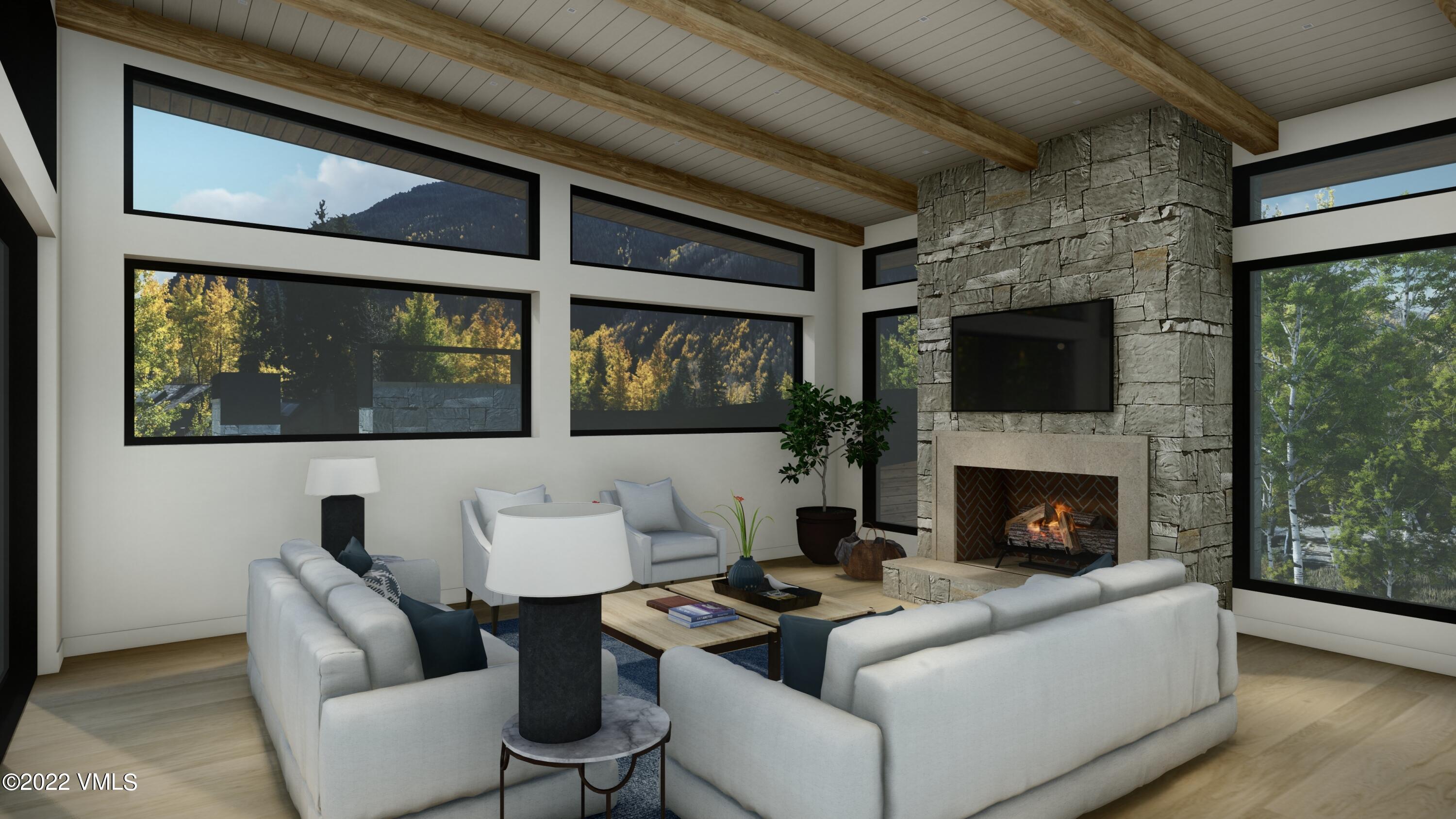 2965 Manns Ranch Road Vail, CO 81657 - Photo 4 of 26 a living room with furniture and a fireplace
