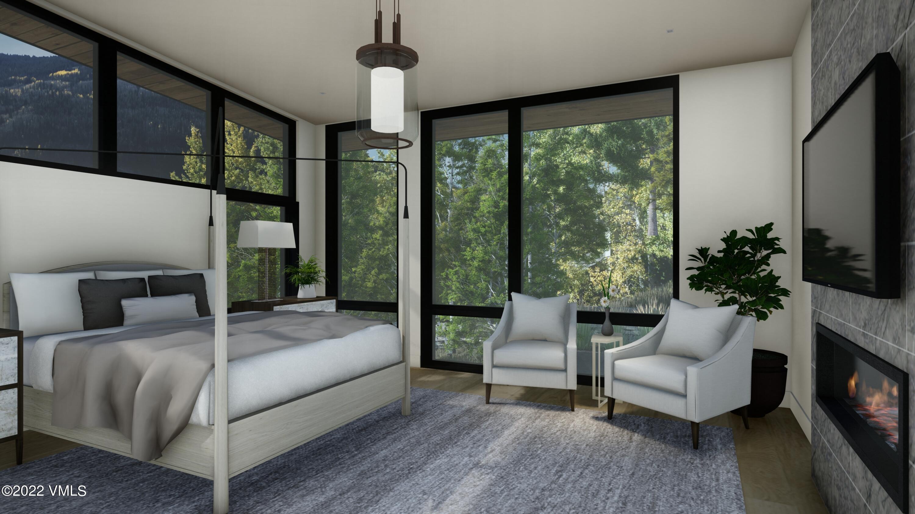 2965 Manns Ranch Road Vail, CO 81657 - Photo 9 of 26 a bedroom with a large bed and a flat screen tv