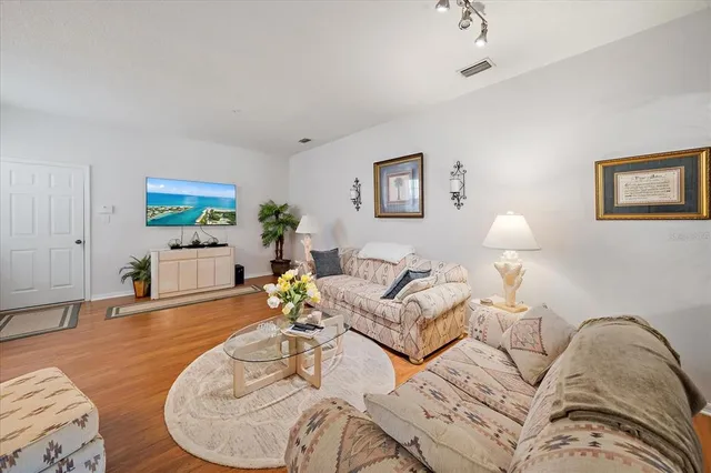 a living room with furniture and wooden floor