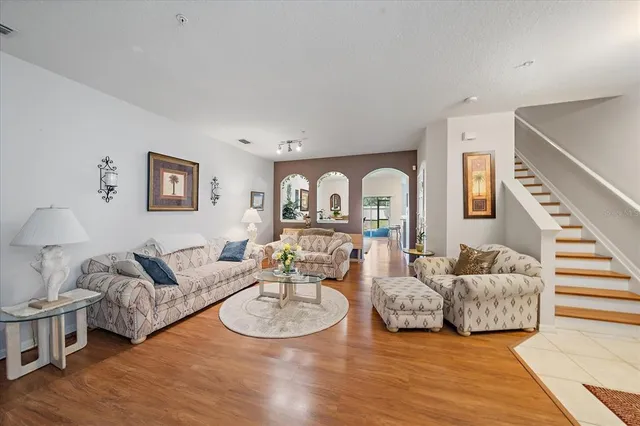 a living room with furniture and wooden floor