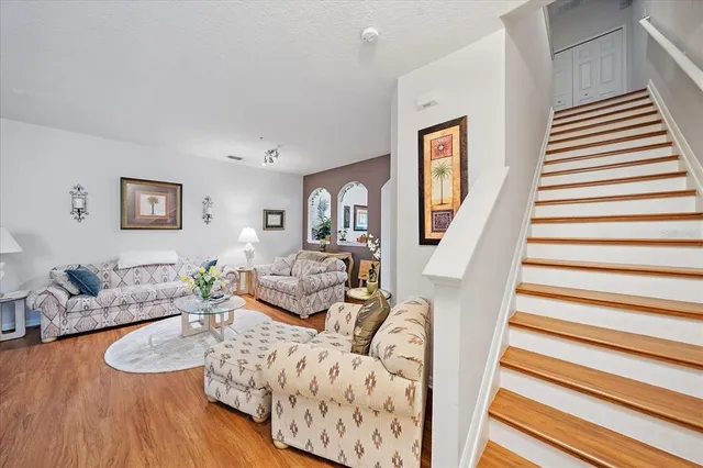a living room with furniture and a wooden floor