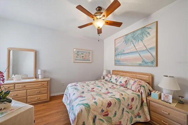 a bedroom with a bed and a painting on the wall