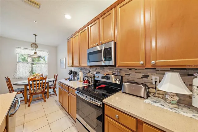 a kitchen with a sink appliances and cabinets