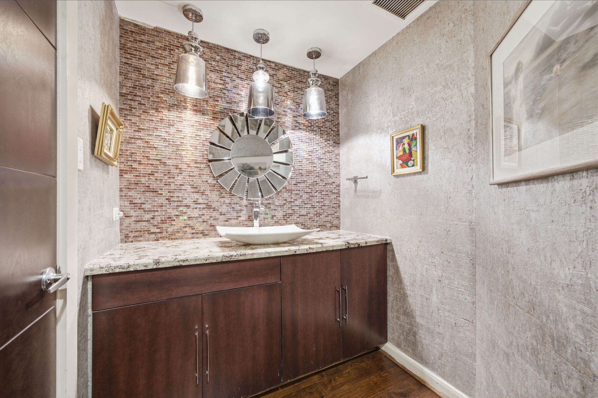 3350 McCue Road, Unit 2402 Houston, TX 77056 - Photo 26 of 49 A shimmering glass mosaic accent wall makes a striking statement in this powder room, complemented by a contemporary vessel sink and polished granite countertop. Rich wood cabinetry, pendant lighting, and warm hardwood floors complete the stylish space.