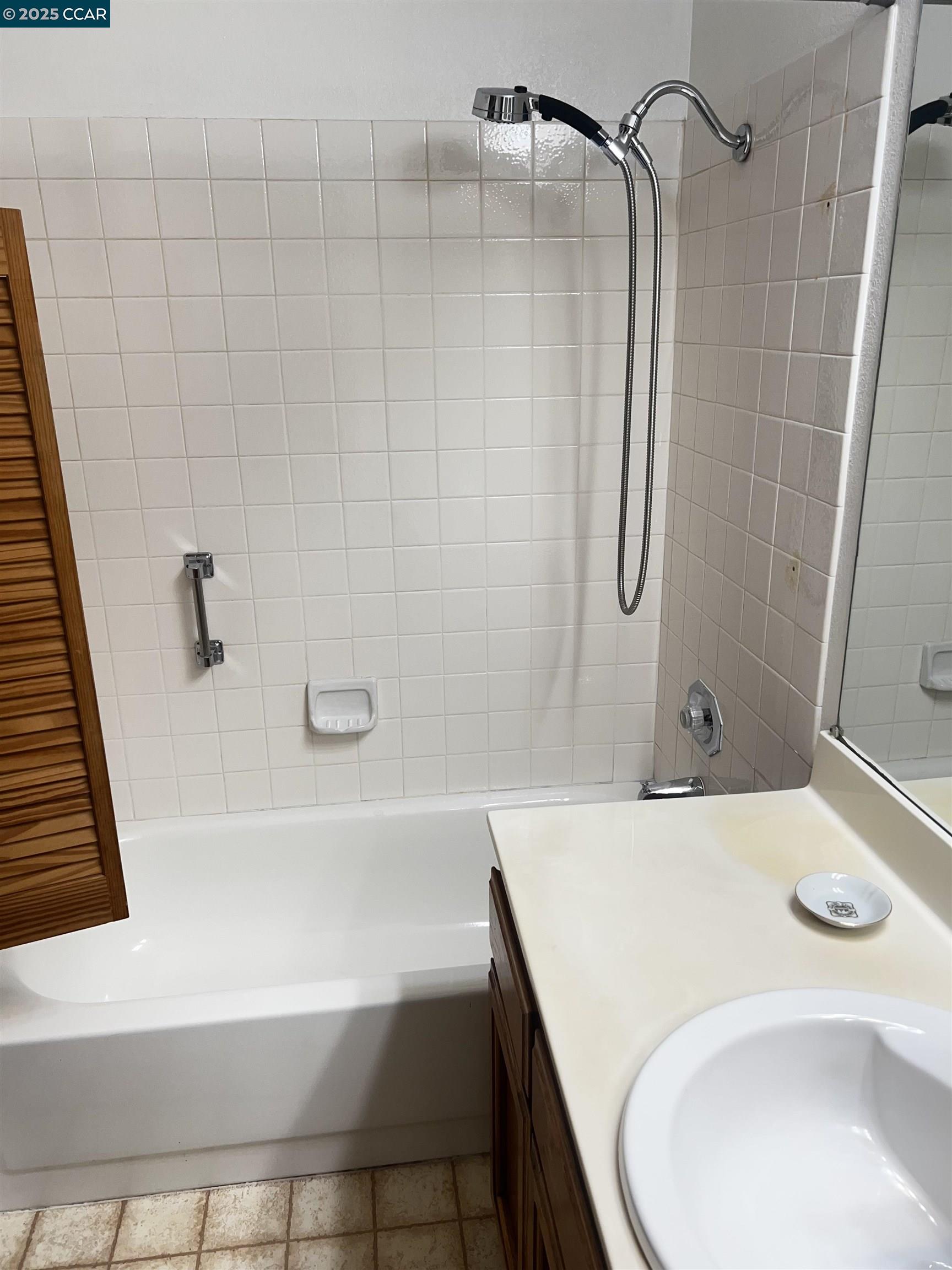 309 Devonwood Hercules, CA 94547 - Photo 16 of 26 a bathroom with a sink a mirror and a shower