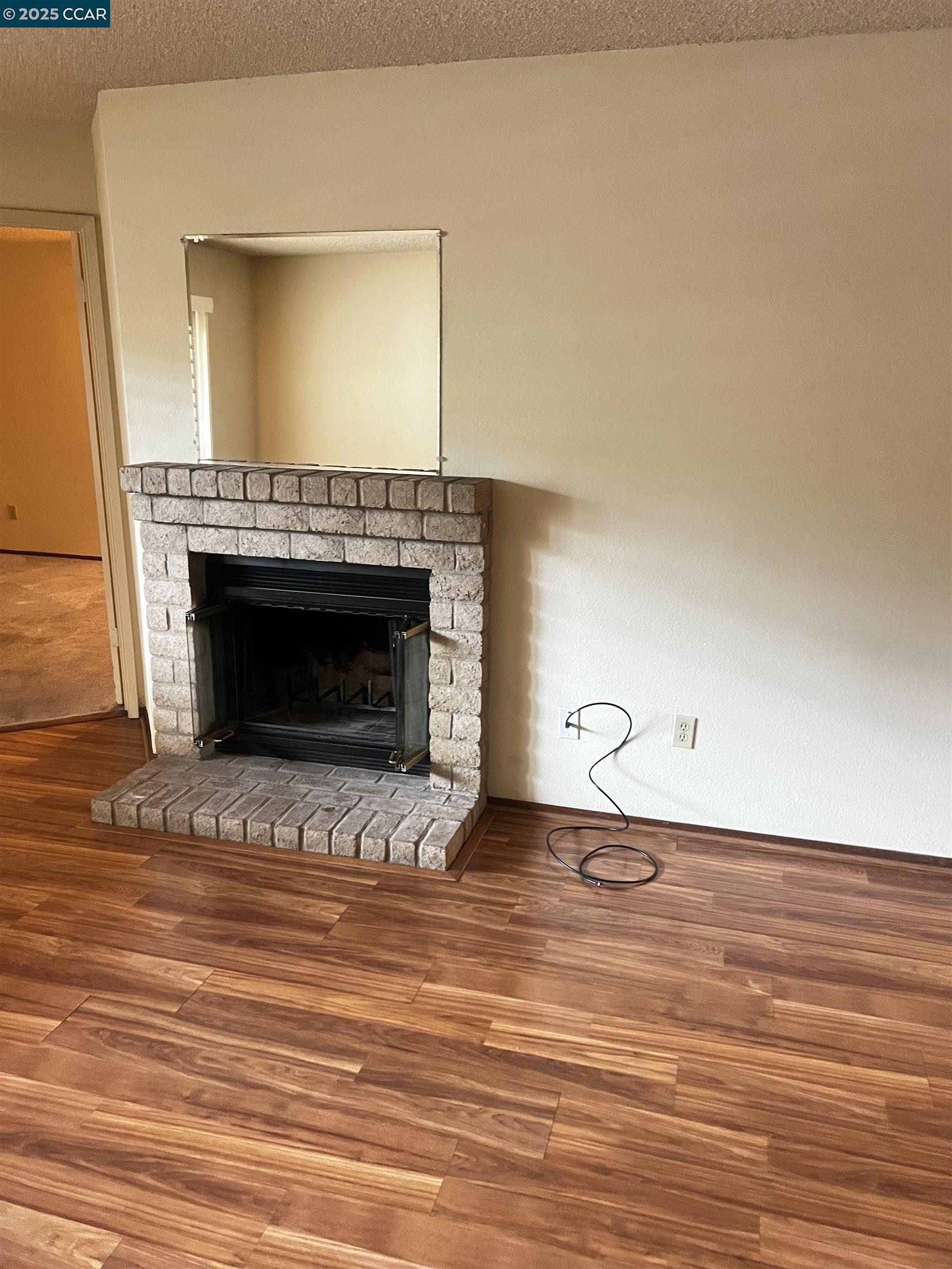 309 Devonwood Hercules, CA 94547 - Photo 22 of 26 a view of empty room with wooden floor and fireplace