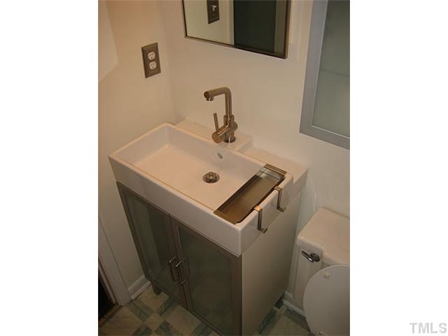 3535 Brentwood Road Raleigh, NC 27604 - Photo 11 of 12 a bathroom with a sink toilet and mirror
