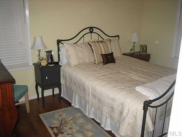 3535 Brentwood Road Raleigh, NC 27604 - Photo 6 of 12 a bedroom with a bed and a dresser