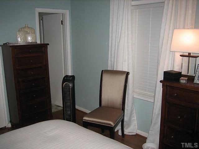 3535 Brentwood Road Raleigh, NC 27604 - Photo 8 of 12 a bedroom with a bed and a lamp on dresser
