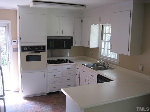 3535 Brentwood Road Raleigh, NC 27604 - Photo 9 of 12 a kitchen with granite countertop a stove and a sink