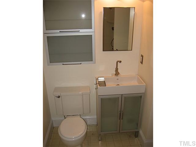3535 Brentwood Road Raleigh, NC 27604 - Photo 10 of 12 a bathroom with a toilet a sink and mirror