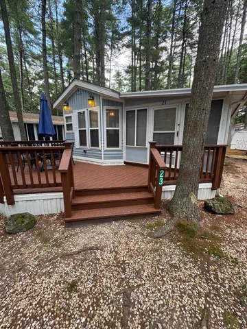 a view of a house with a yard and sitting area
