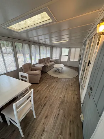 a hallway with chairs and a wooden floor