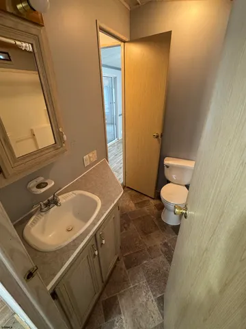 a bathroom with a sink a toilet and mirror
