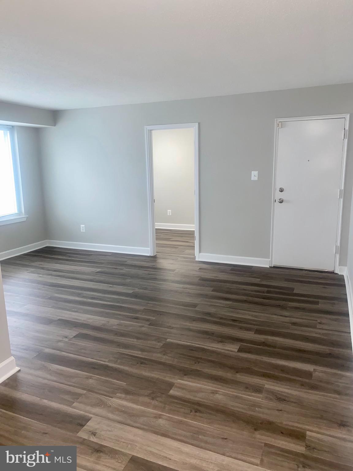 a view of room with wooden floor