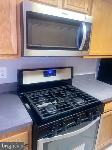a stove top oven sitting inside of a kitchen