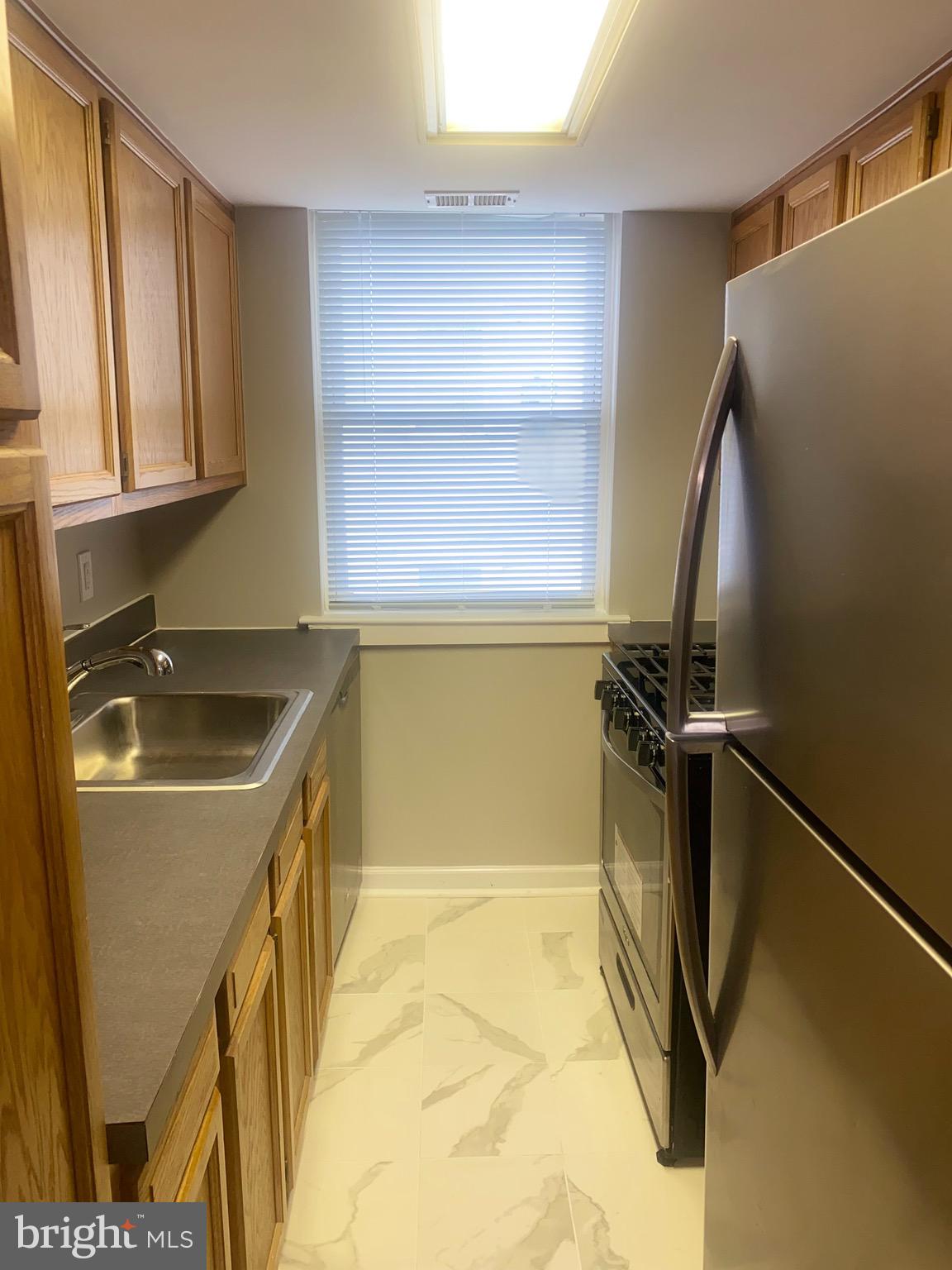 718 Brandywine Street Southeast, Unit 202 Washington, DC 20032 - Photo 8 of 10 a utility room with a sink a washer and dryer